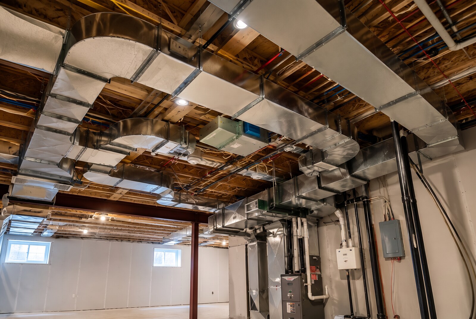 Custom-fabricated galvanized supply and return ductwork installed on a commercial ceiling